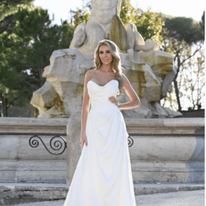 IVORY – Strapless, plain soft satin A-line with draped detail on front bodice & skirt. Gathered back skirt with pearl button trim & optional large detachable bow with tail included unless ordering dress only.